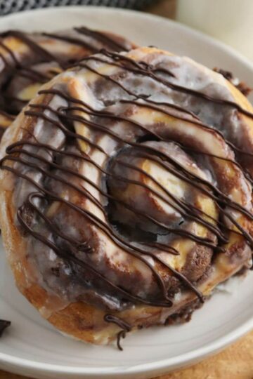 brownie cinnamon rolls being served on a white plate