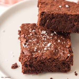 Sheet pan brownies cut into squares and served on a plate.