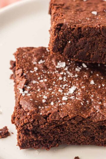Sheet pan brownies cut into squares and served on a plate.